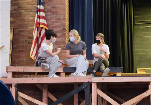 Members of the cast (left to right), Chris Stypa, Julia Coon and Katie Shapiro, rehearse in their roles as schoolchildren.